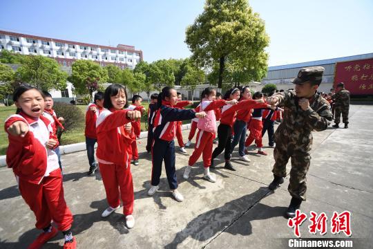 资料图：小学生进警营接受国家安全教育，武警官兵传授擒敌拳。周亮摄